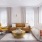Model living room at our apartments for rent in Westbury, featuring couches, wood grain flooring, and natural light.