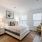 Bedroom with a bed with two bedside tables and a yellow chair.