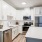 Kitchen with white cabinets and a large island.